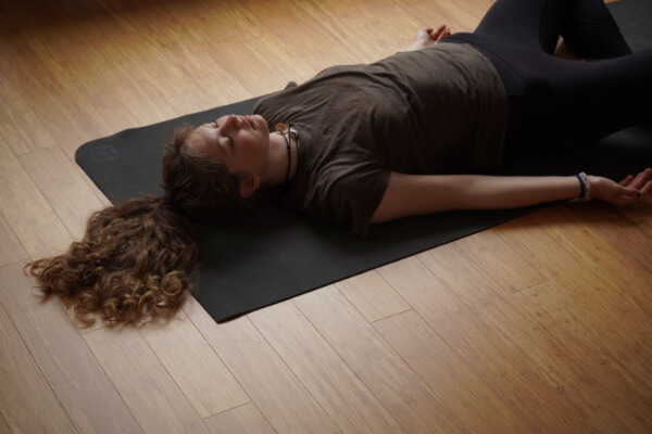 Person lying on a yoga mat